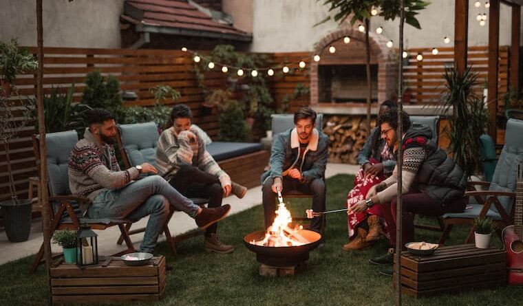group of friends making smores on a portable outdoor firepit
